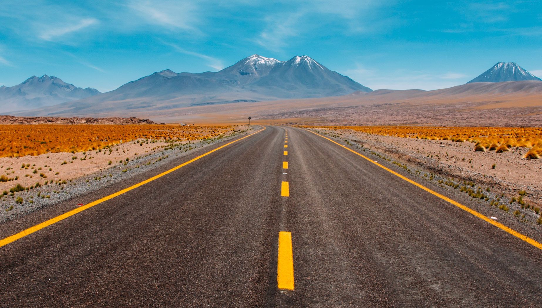 Long Open Road with Mountains in the Background